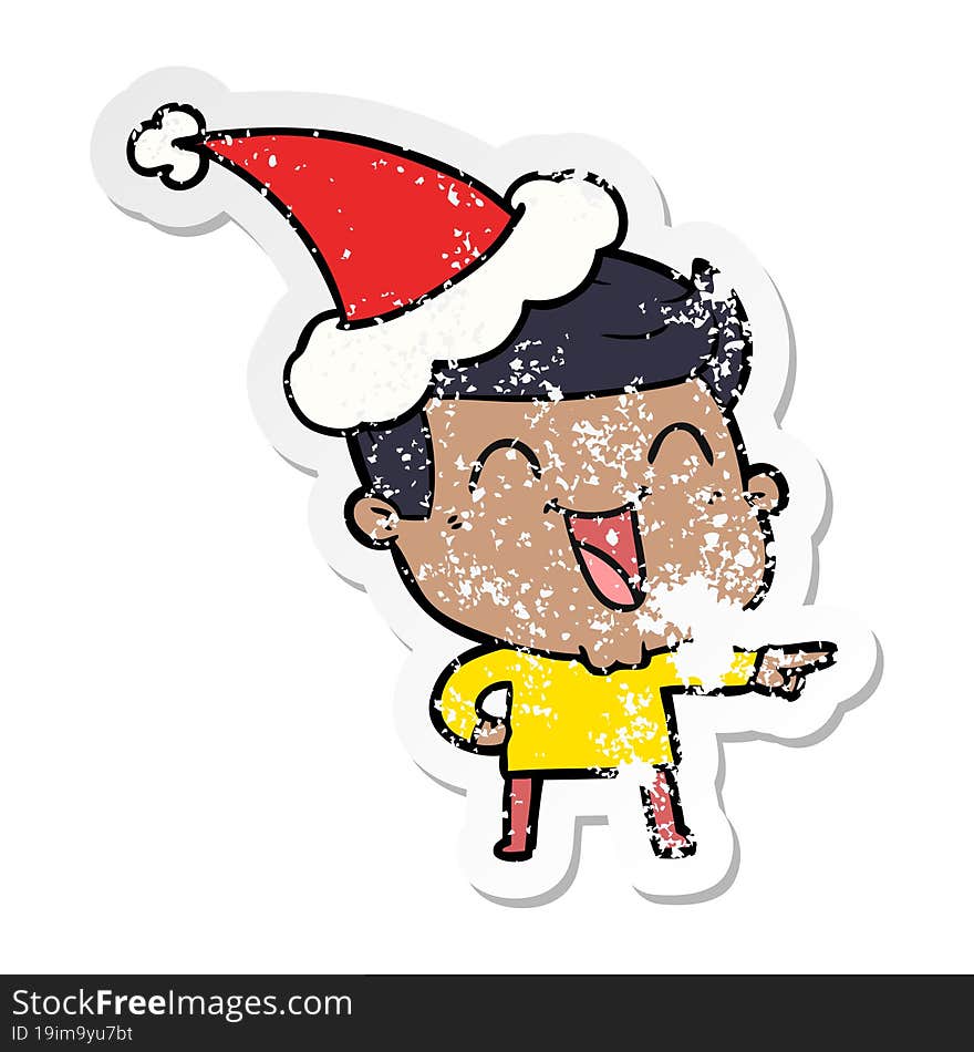 distressed sticker cartoon of a man laughing wearing santa hat