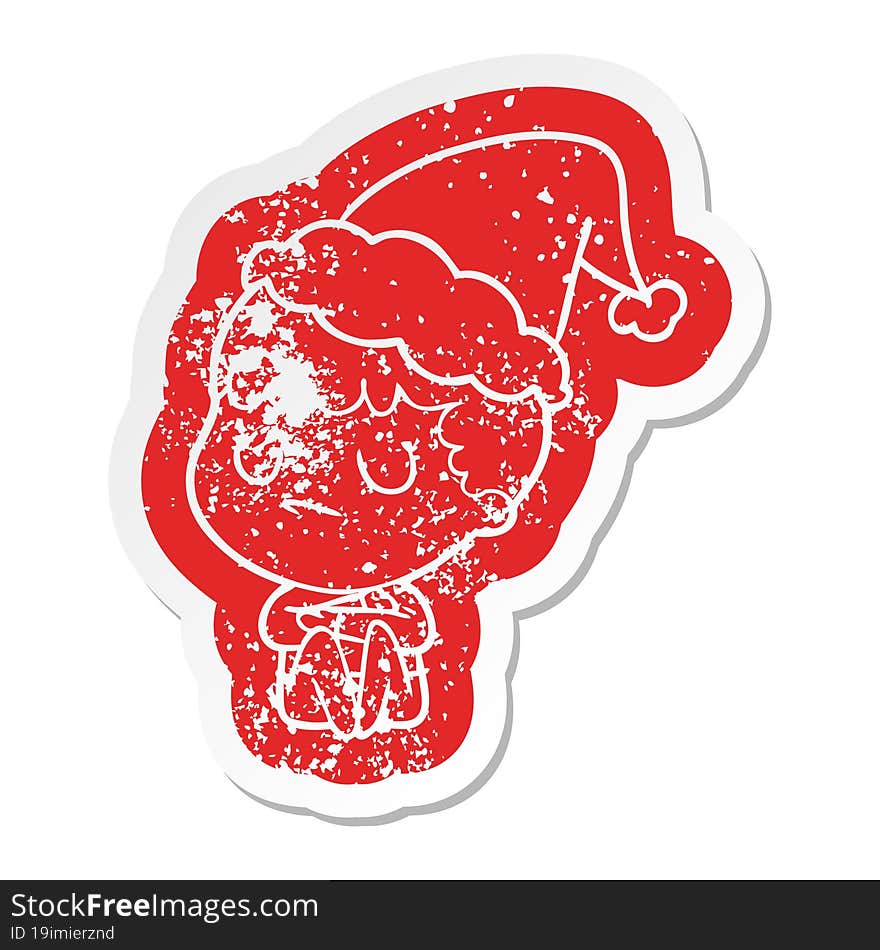 cartoon distressed sticker of a grumpy boy wearing santa hat