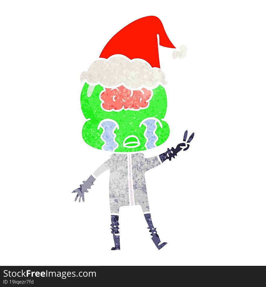 hand drawn retro cartoon of a big brain alien crying and giving peace sign wearing santa hat