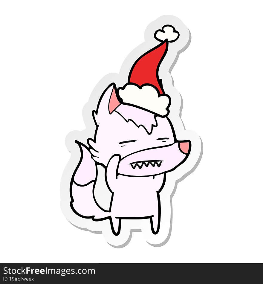 Sticker Cartoon Of A Wolf Showing Teeth Wearing Santa Hat