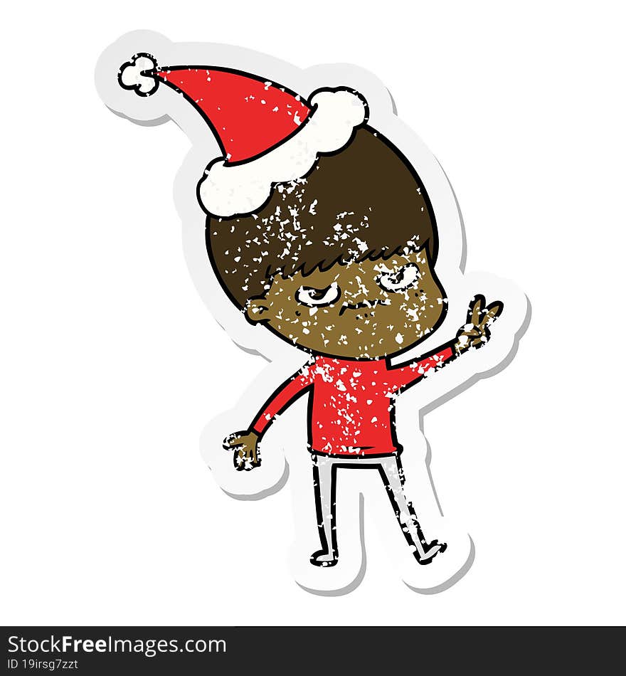 annoyed distressed sticker cartoon of a boy wearing santa hat