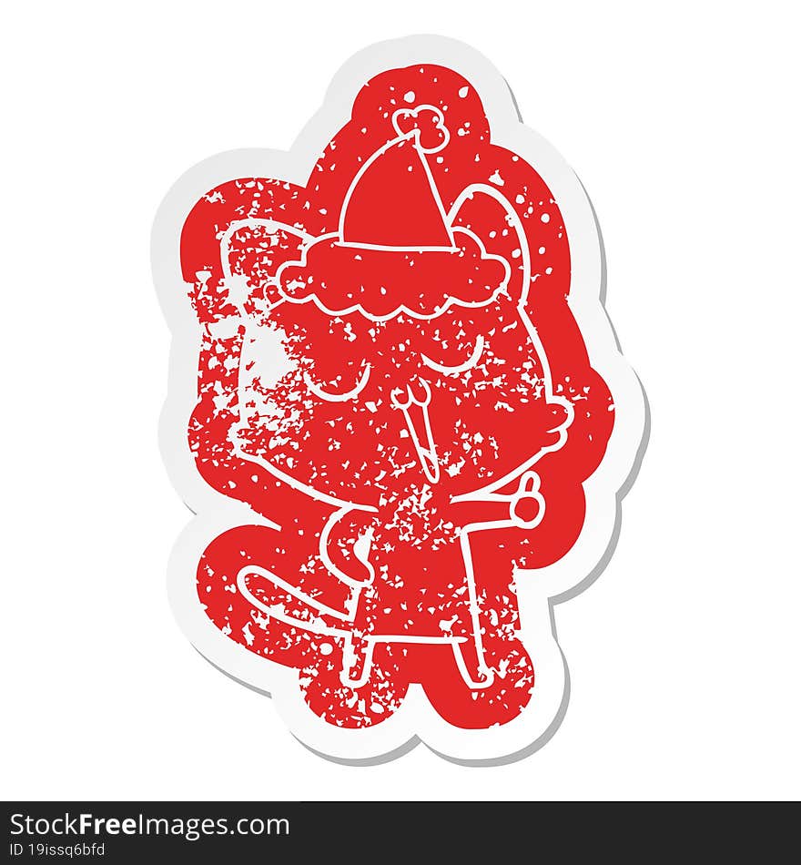 cartoon distressed sticker of a cat singing wearing santa hat