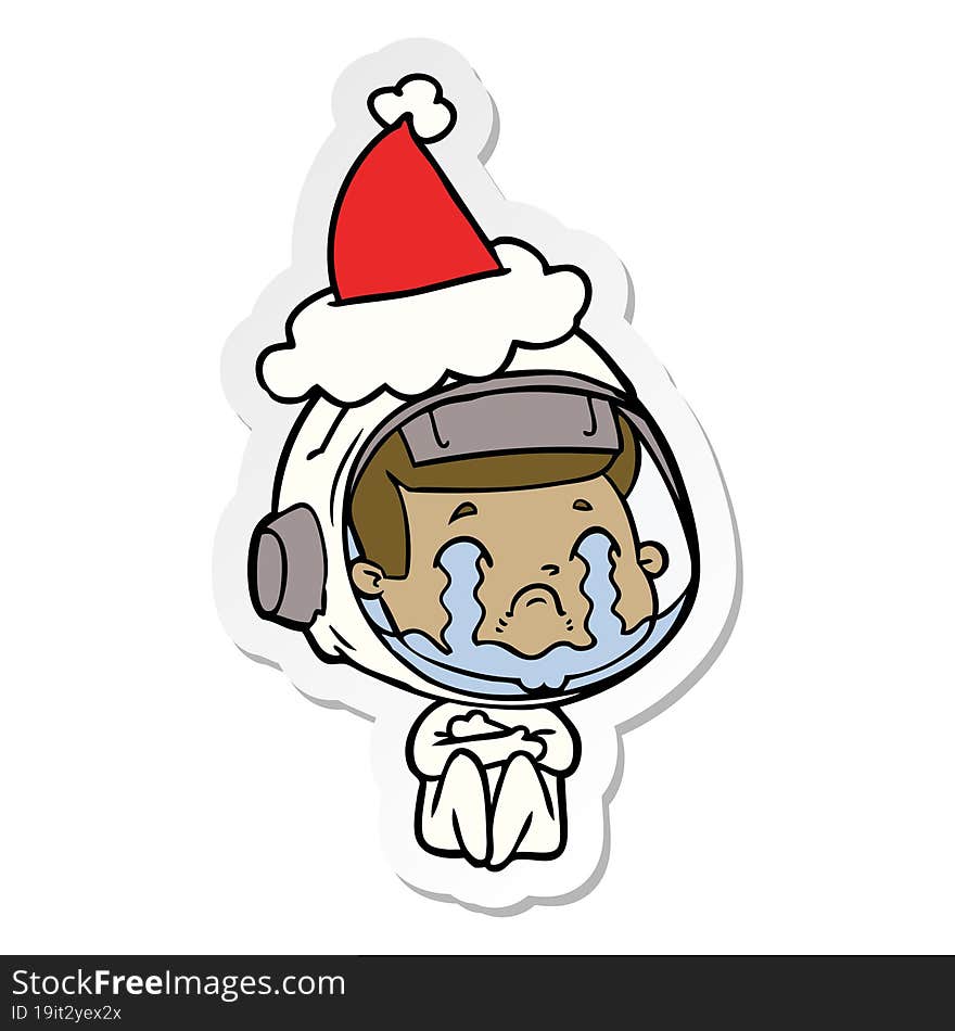 sticker cartoon of a crying astronaut wearing santa hat