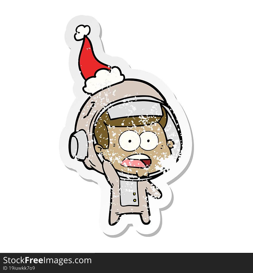 distressed sticker cartoon of a surprised astronaut wearing santa hat