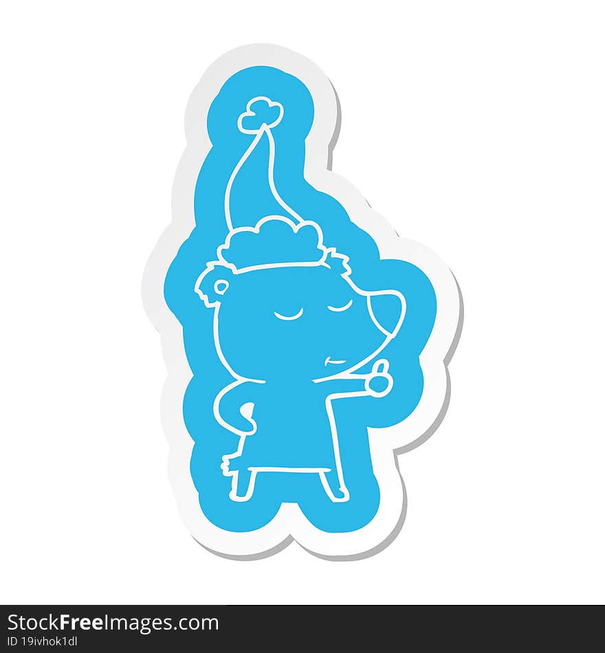 happy cartoon  sticker of a bear giving thumbs up wearing santa hat