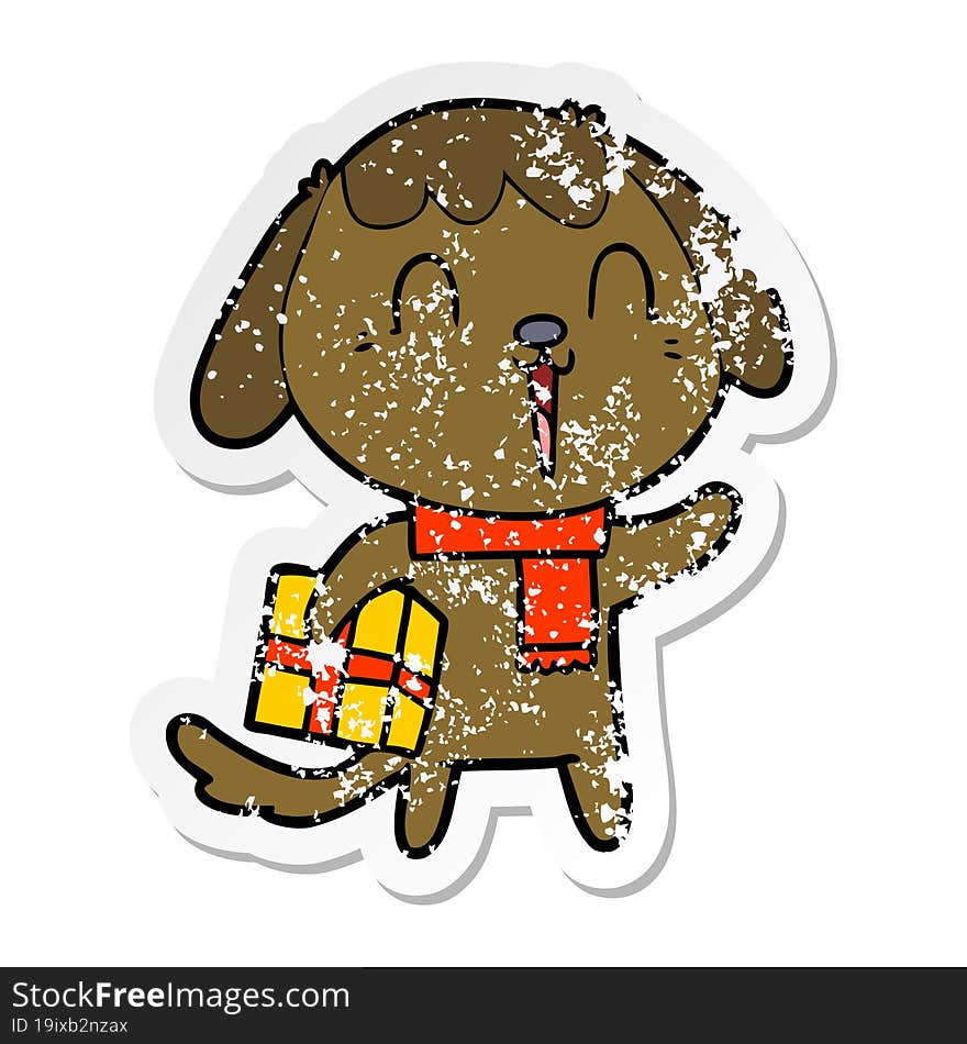 distressed sticker of a cute cartoon dog with christmas present