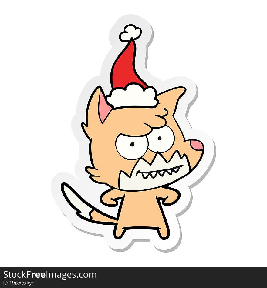 sticker cartoon of a grinning fox wearing santa hat