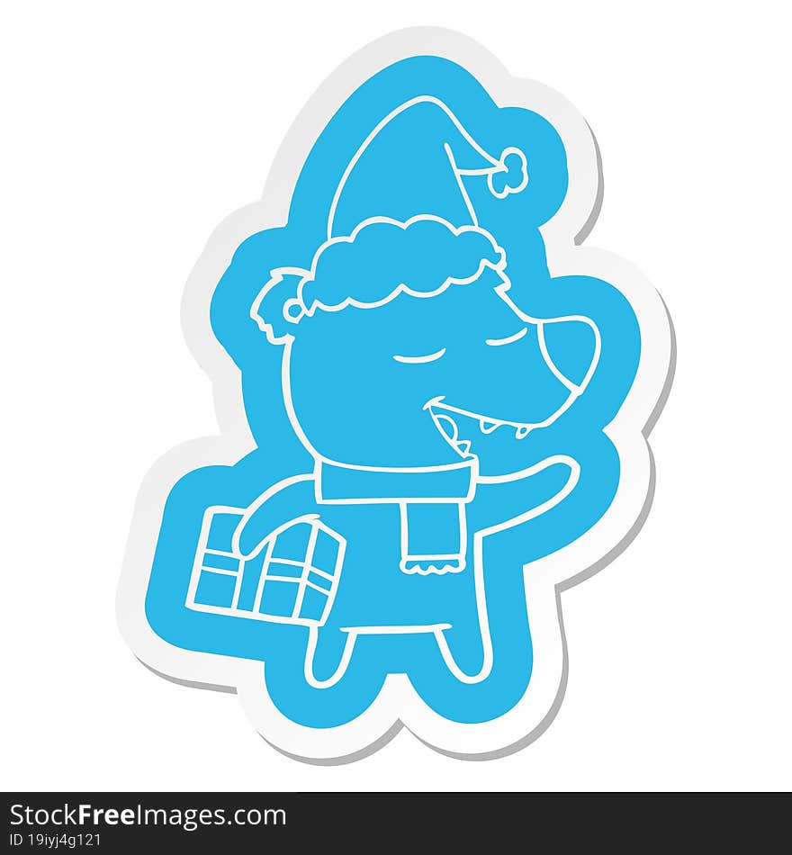 cartoon  sticker of a bear with present wearing santa hat