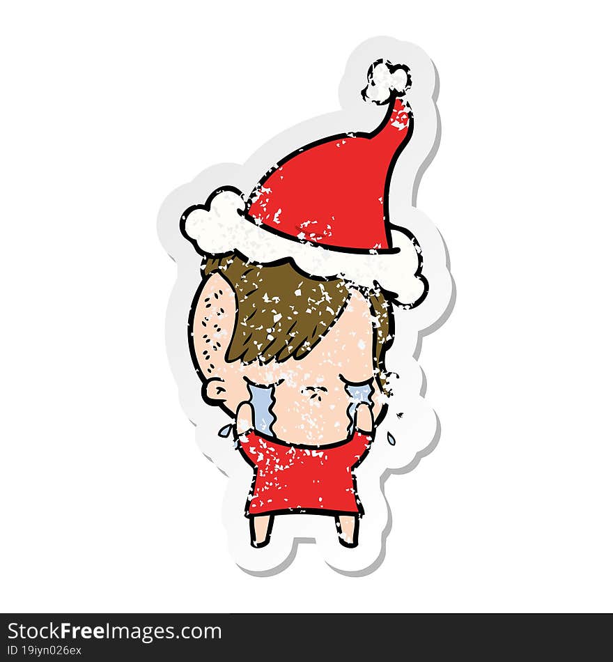 distressed sticker cartoon of a crying girl wearing santa hat