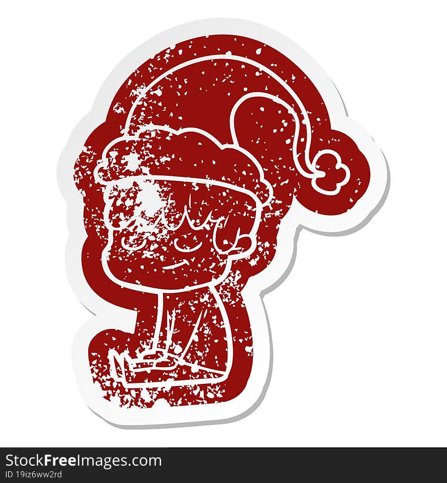 Cartoon Distressed Sticker Of A Happy Boy Wearing Santa Hat