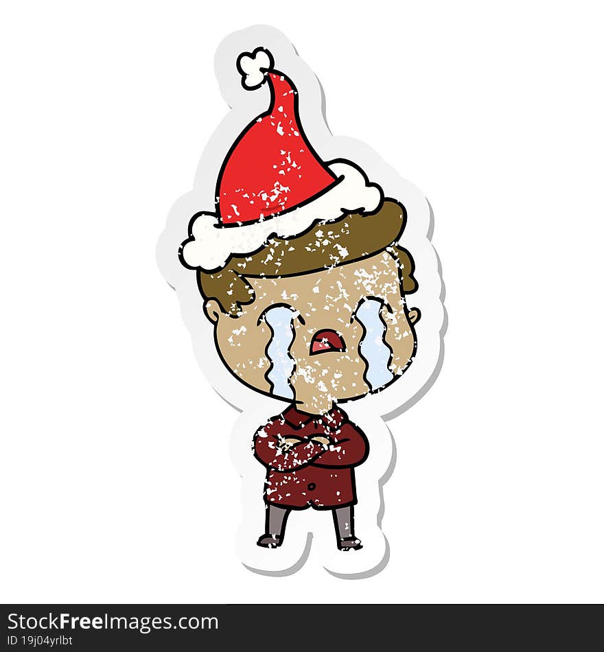 distressed sticker cartoon of a man crying wearing santa hat