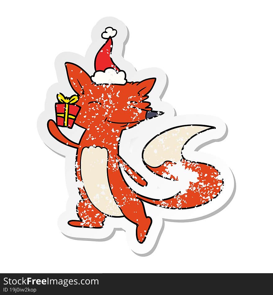 distressed sticker cartoon of a happy fox wearing santa hat