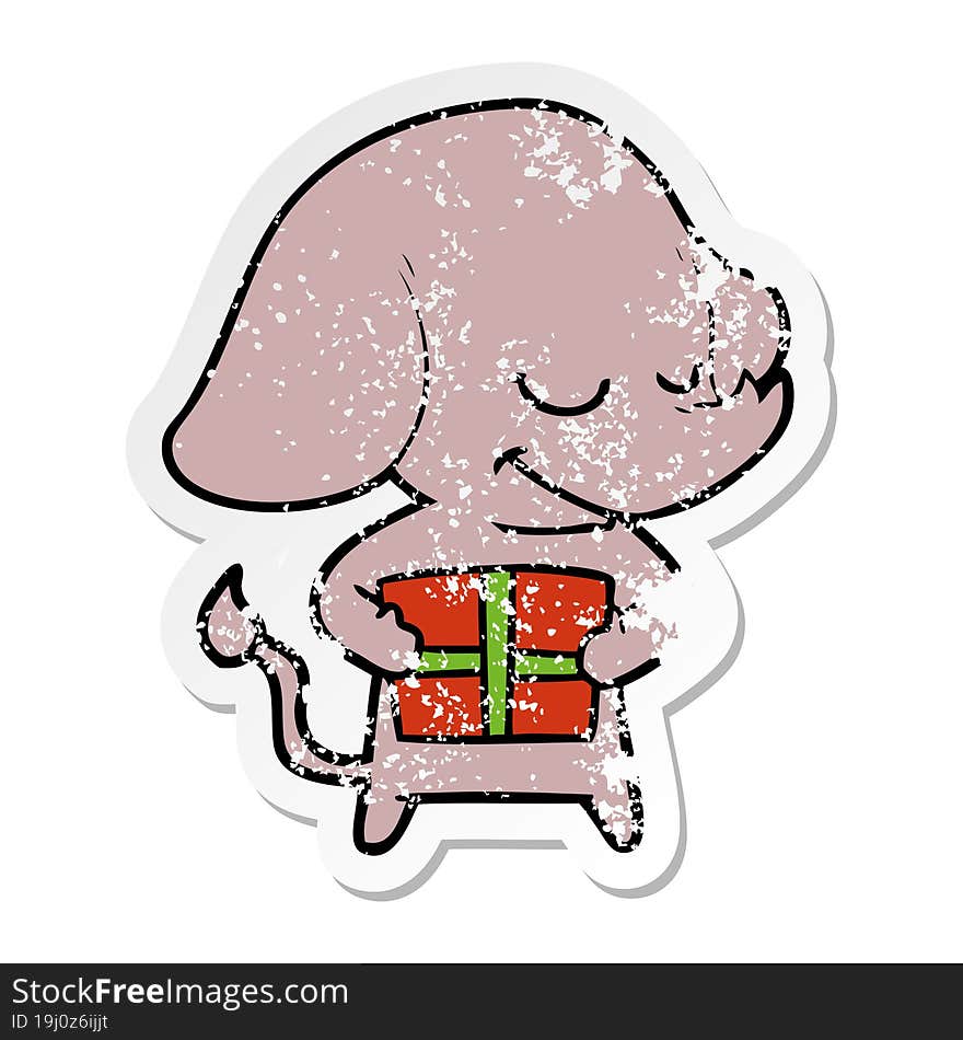 distressed sticker of a cartoon smiling elephant with present