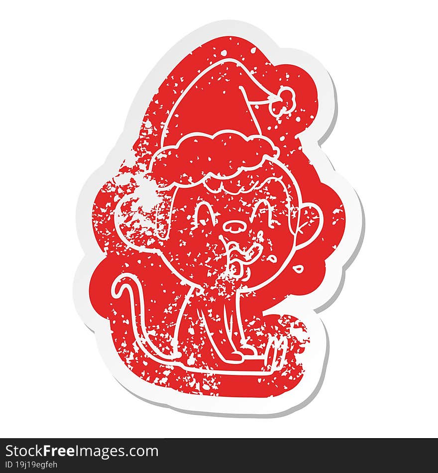 crazy cartoon distressed sticker of a monkey sitting wearing santa hat