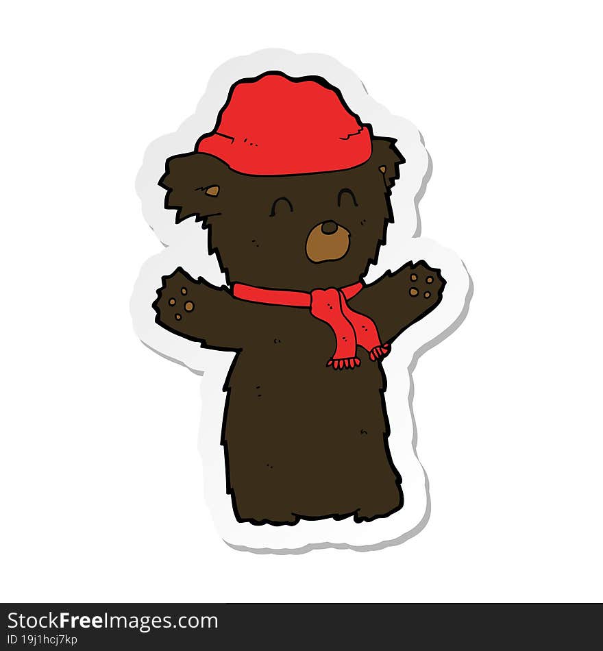 sticker of a cartooon cute black bear in hat and scarf