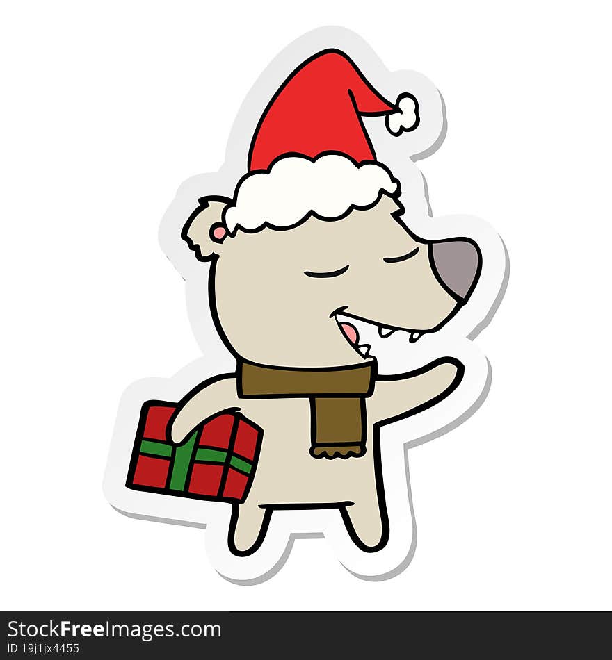 sticker cartoon of a bear with present wearing santa hat