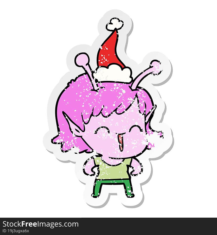 hand drawn distressed sticker cartoon of a alien girl laughing wearing santa hat