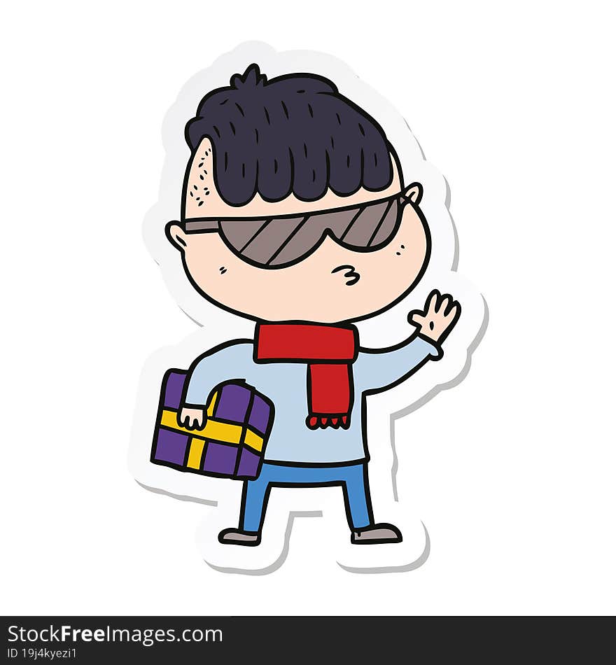 sticker of a cartoon boy wearing sunglasses carrying xmas gift