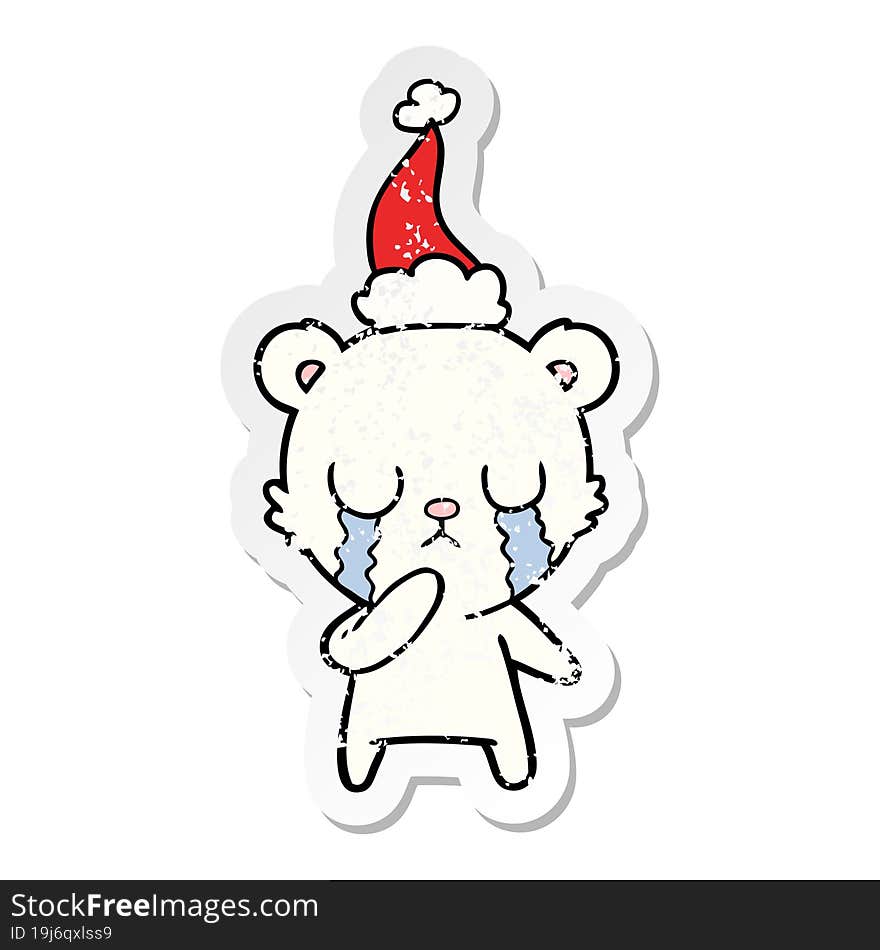 crying polar bear hand drawn distressed sticker cartoon of a wearing santa hat