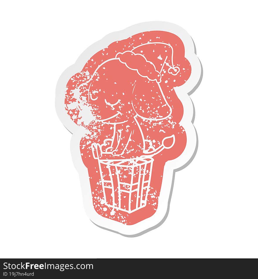 cartoon distressed sticker of a smiling elephant wearing santa hat