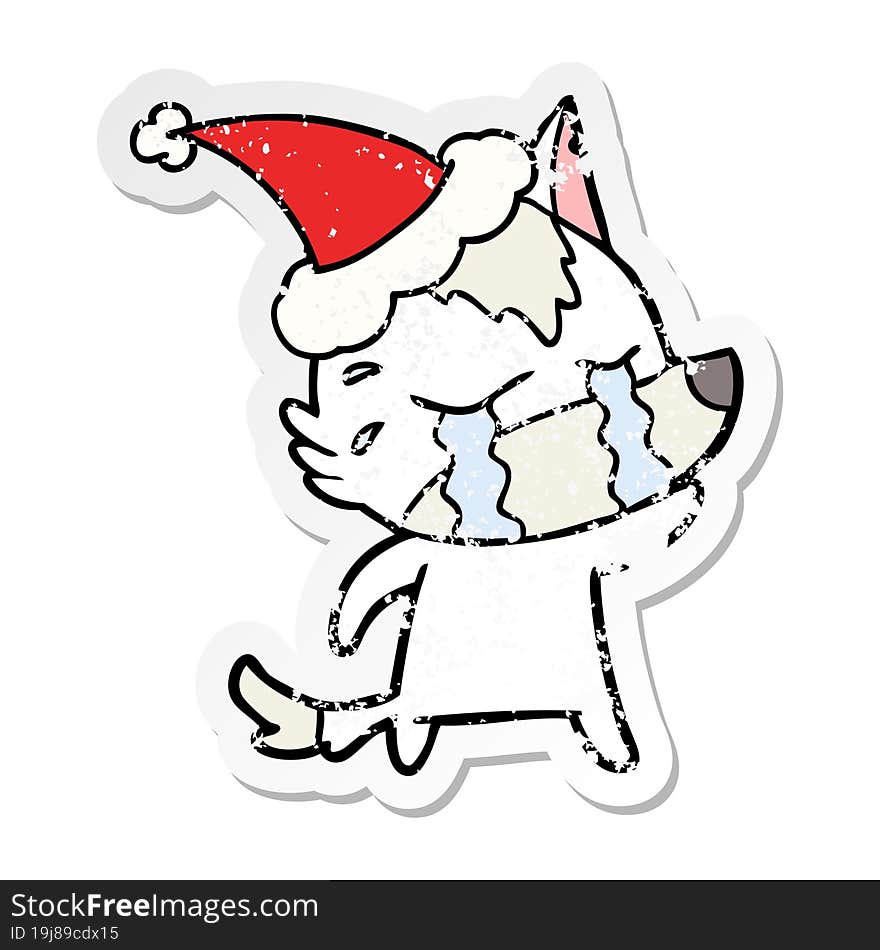 distressed sticker cartoon of a crying wolf wearing santa hat