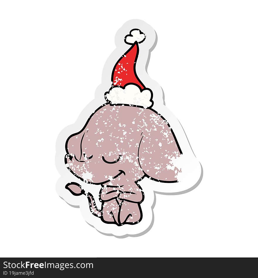 distressed sticker cartoon of a smiling elephant wearing santa hat