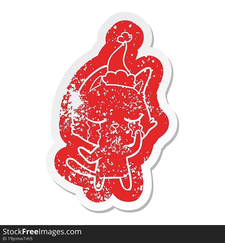 crying cartoon distressed sticker of a cat wearing santa hat