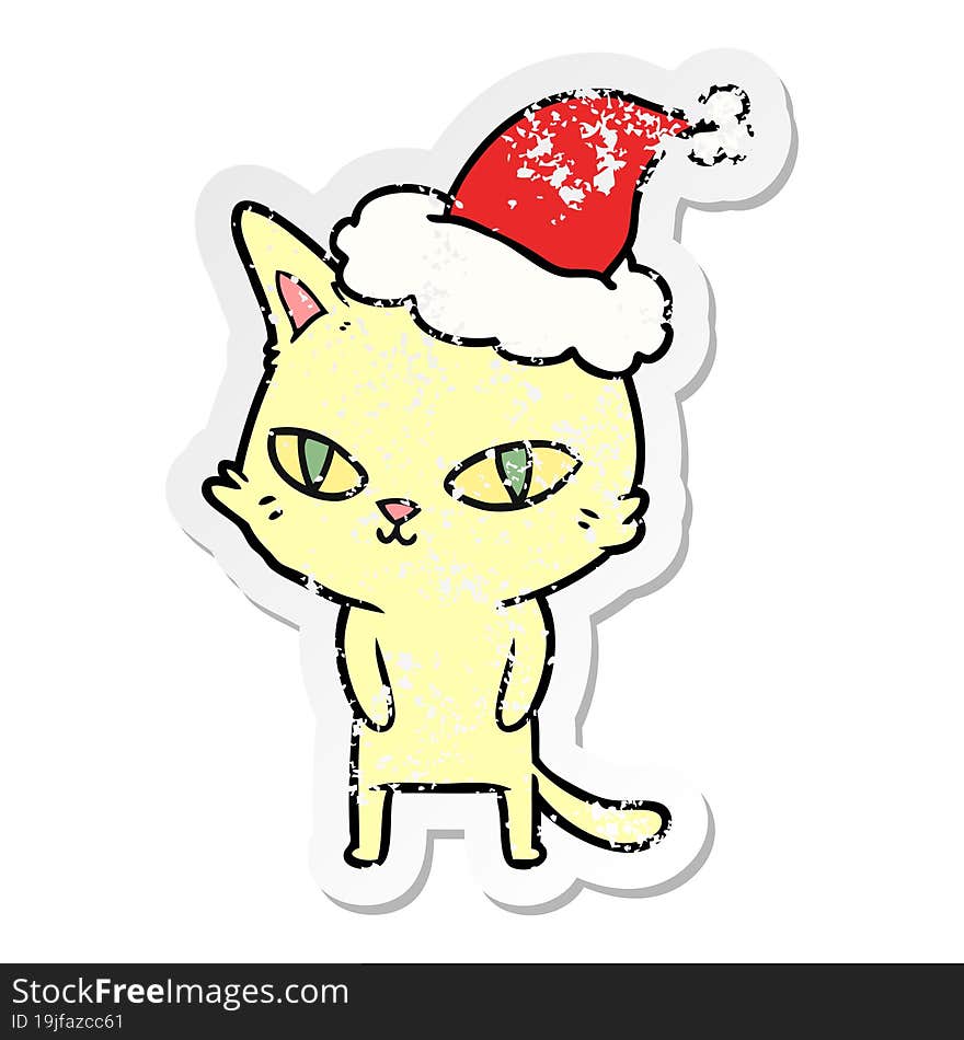 distressed sticker cartoon of a cat with bright eyes wearing santa hat