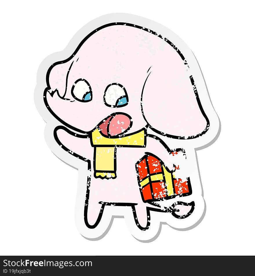 distressed sticker of a cute cartoon elephant with christmas present