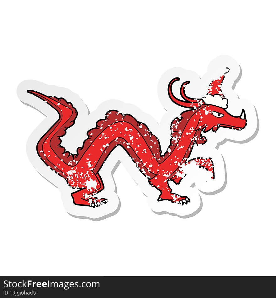 distressed sticker cartoon of a dragon wearing santa hat