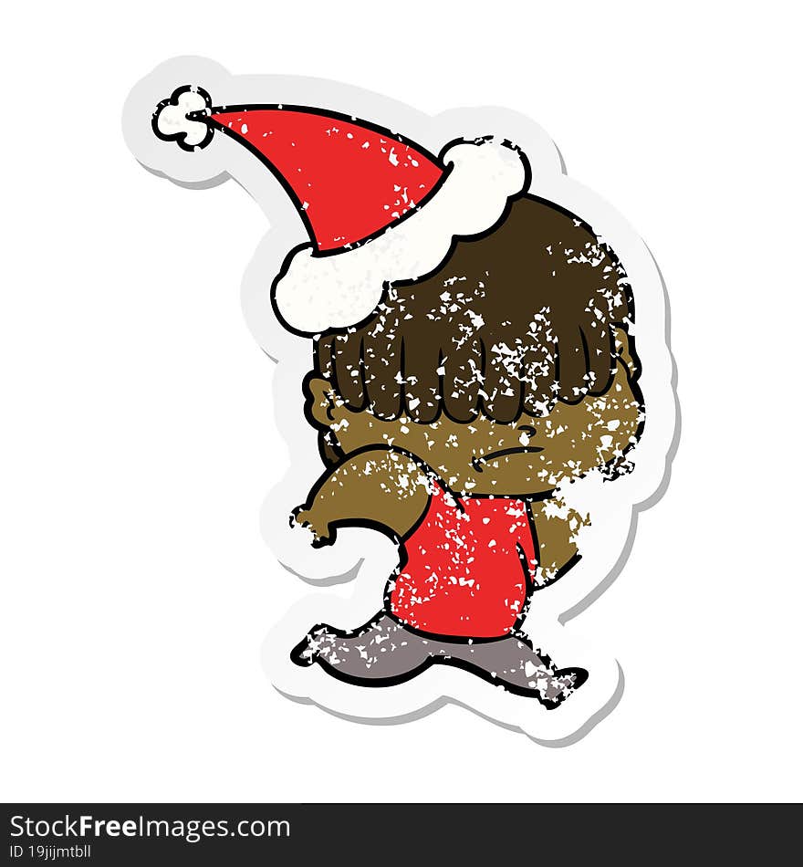 Distressed Sticker Cartoon Of A Boy With Untidy Hair Wearing Santa Hat