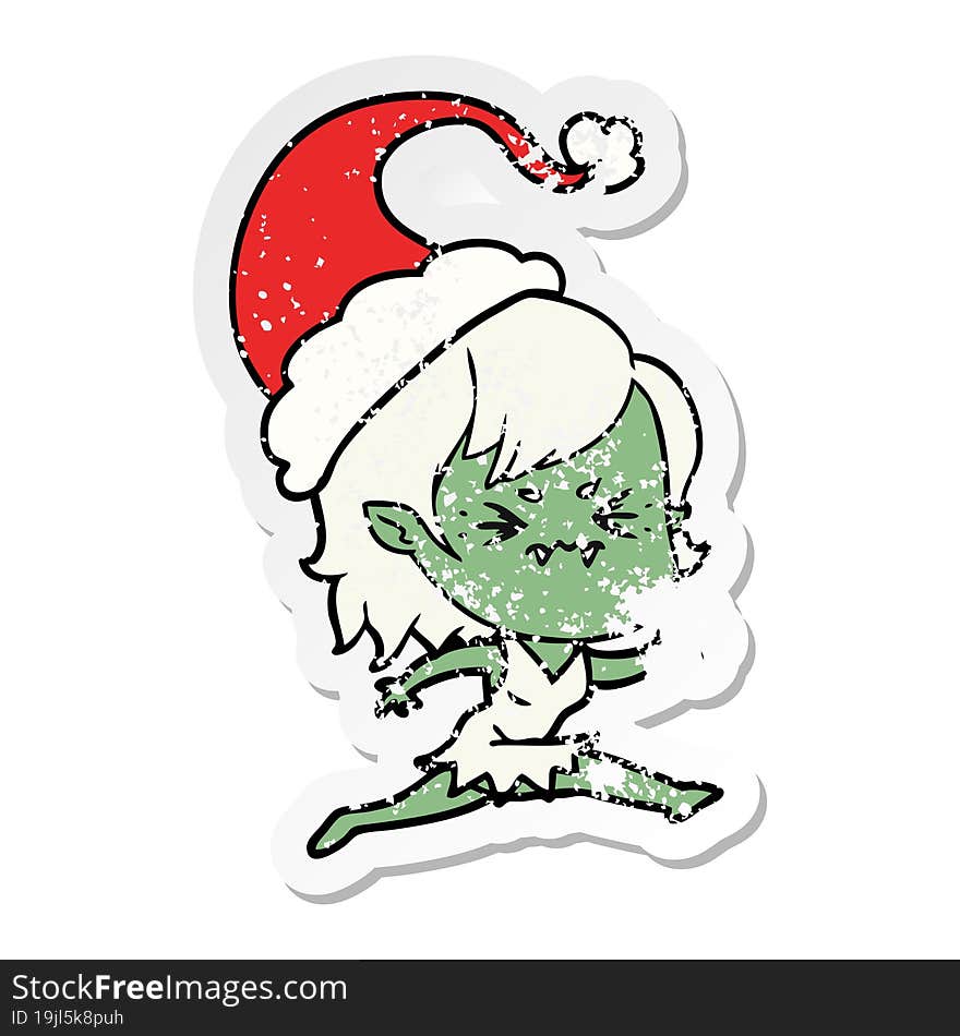 annoyed distressed sticker cartoon of a vampire girl wearing santa hat