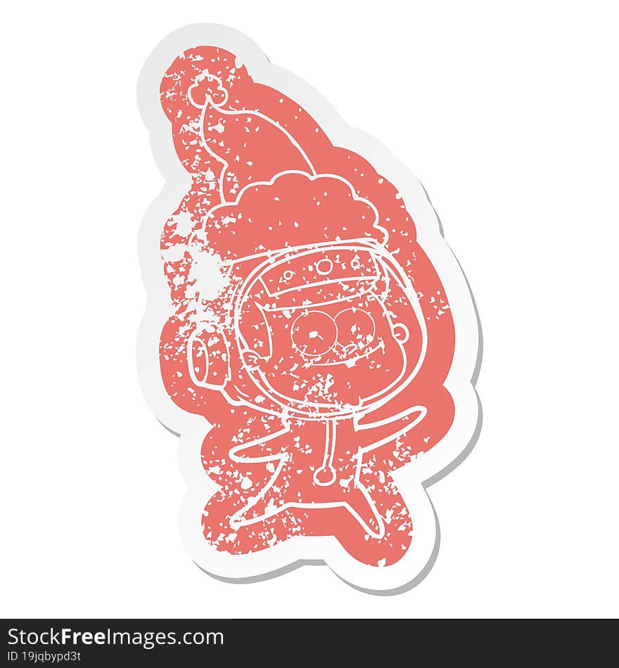 happy astronaut cartoon distressed sticker of a wearing santa hat