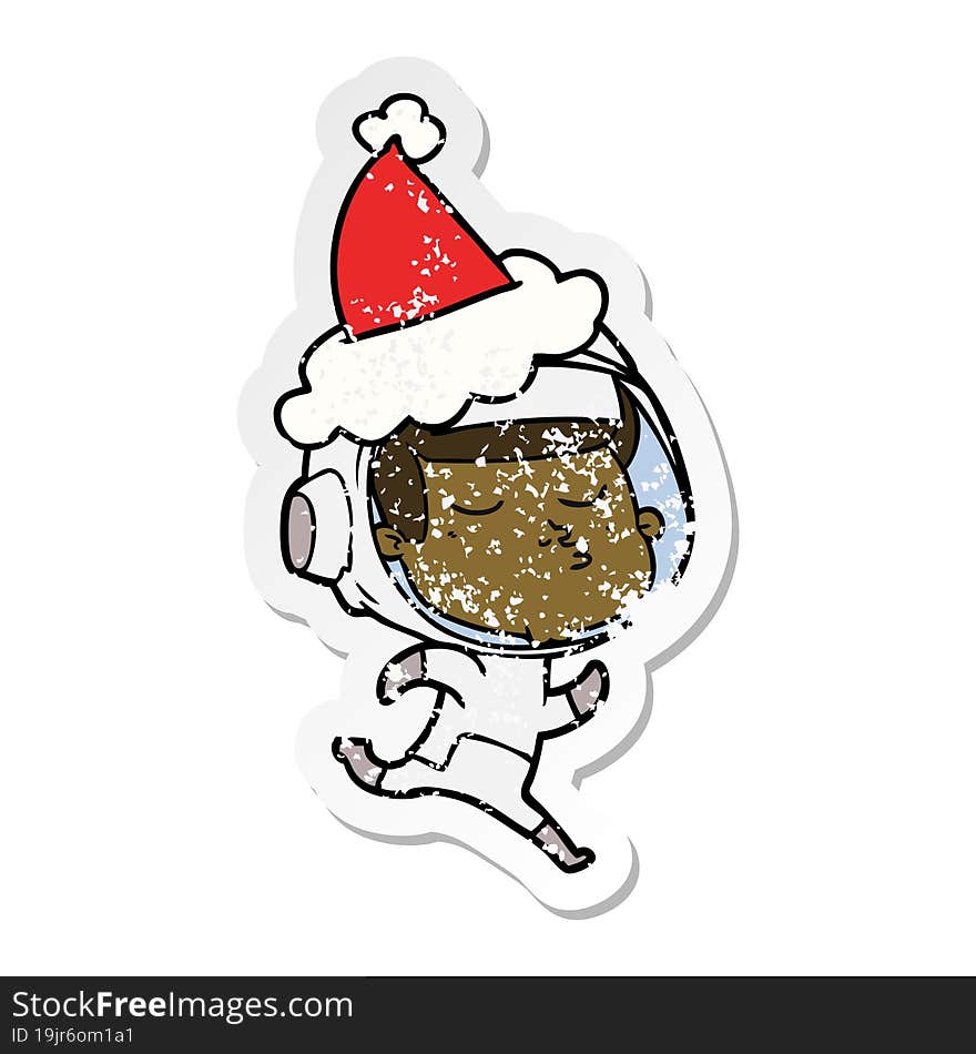 distressed sticker cartoon of a confident astronaut wearing santa hat