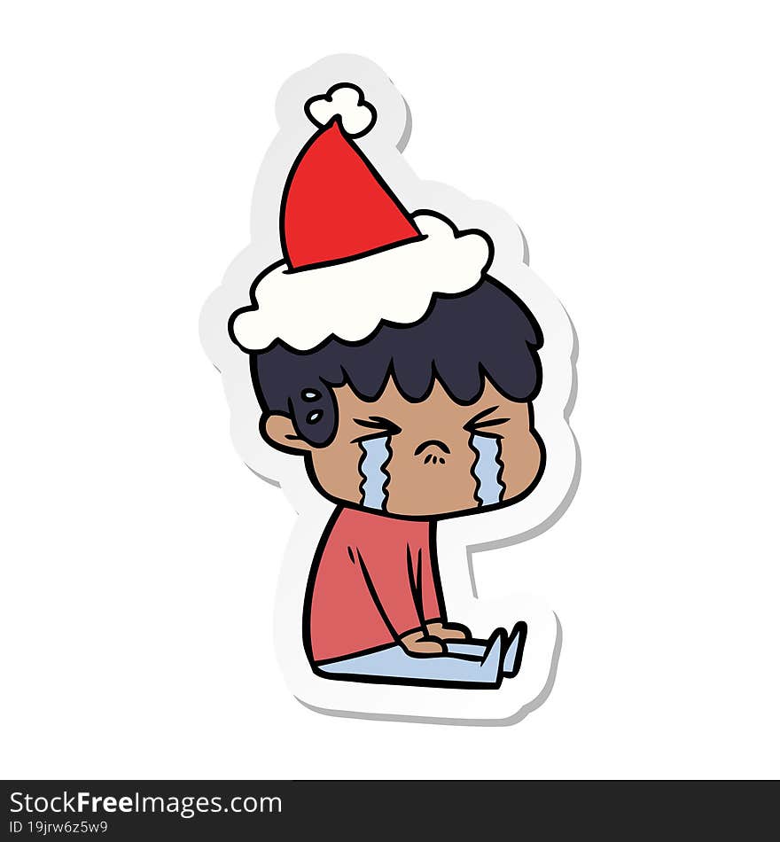 sticker cartoon of a boy crying wearing santa hat