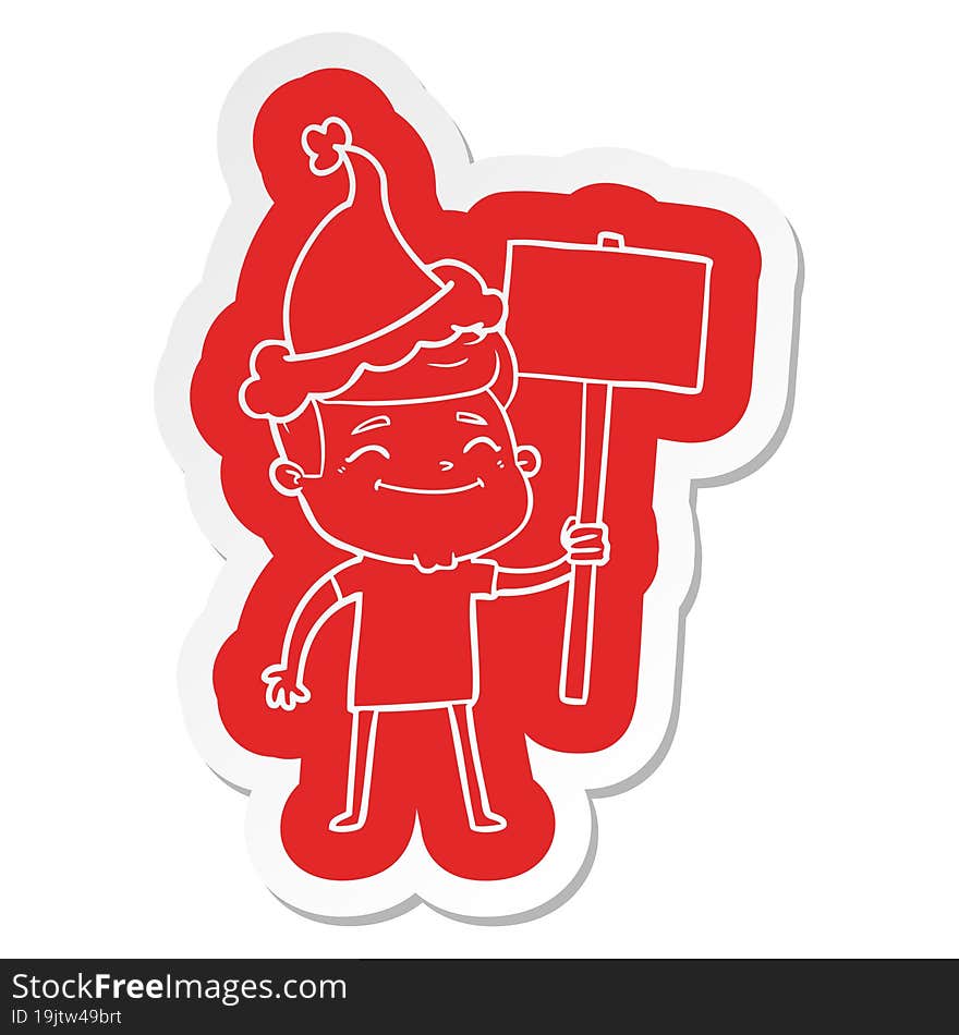 happy quirky cartoon  sticker of a man with placard wearing santa hat