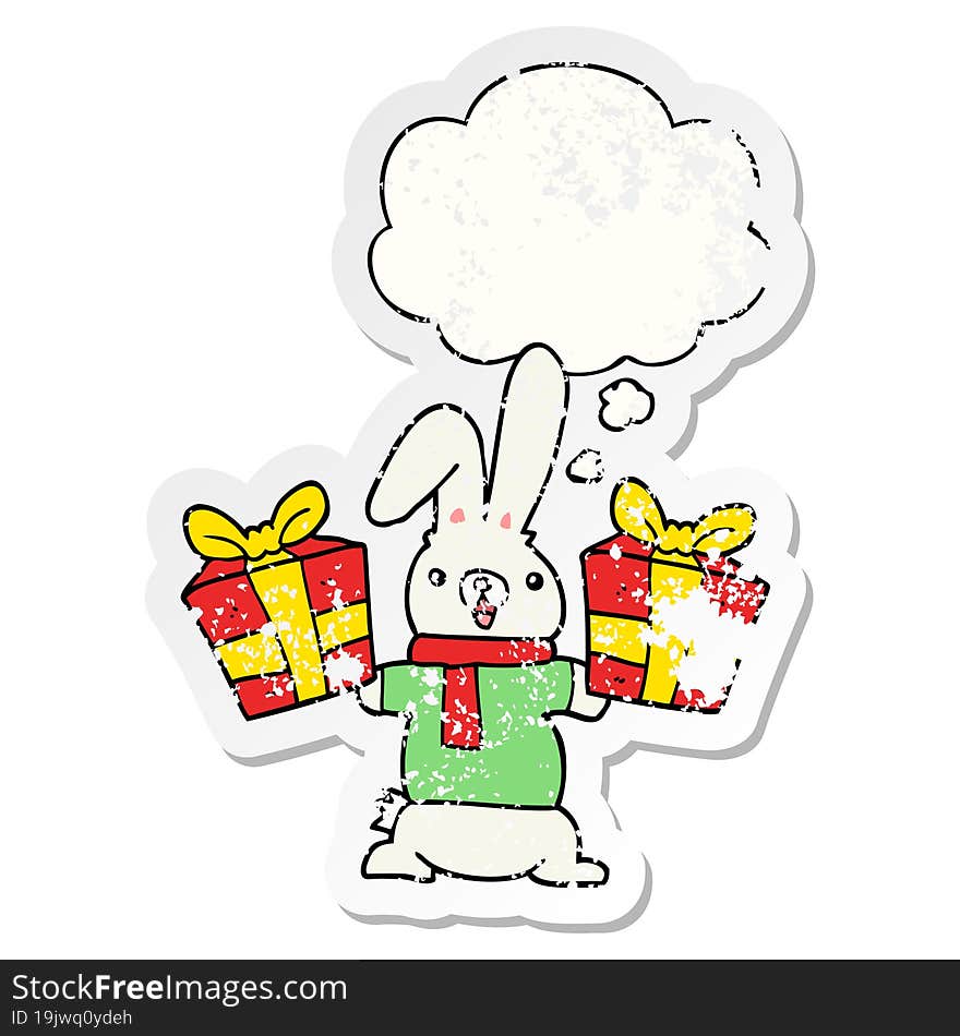 cartoon rabbit with christmas presents and thought bubble as a distressed worn sticker