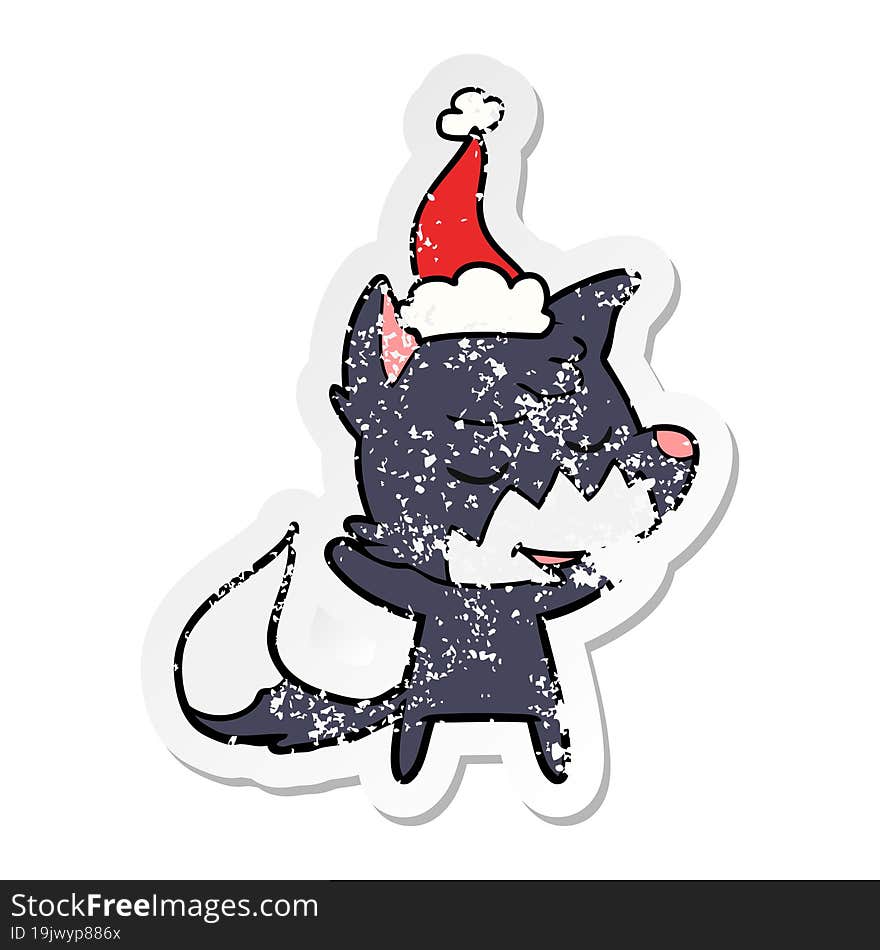 friendly distressed sticker cartoon of a fox wearing santa hat