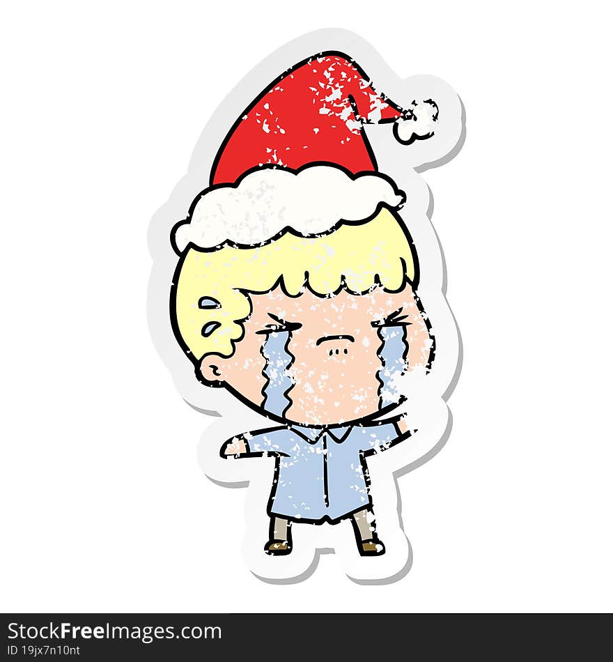 distressed sticker cartoon of a man crying wearing santa hat