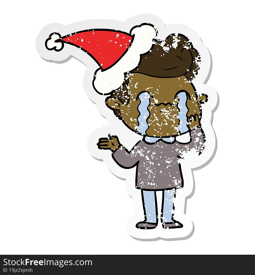 distressed sticker cartoon of a man crying wearing santa hat