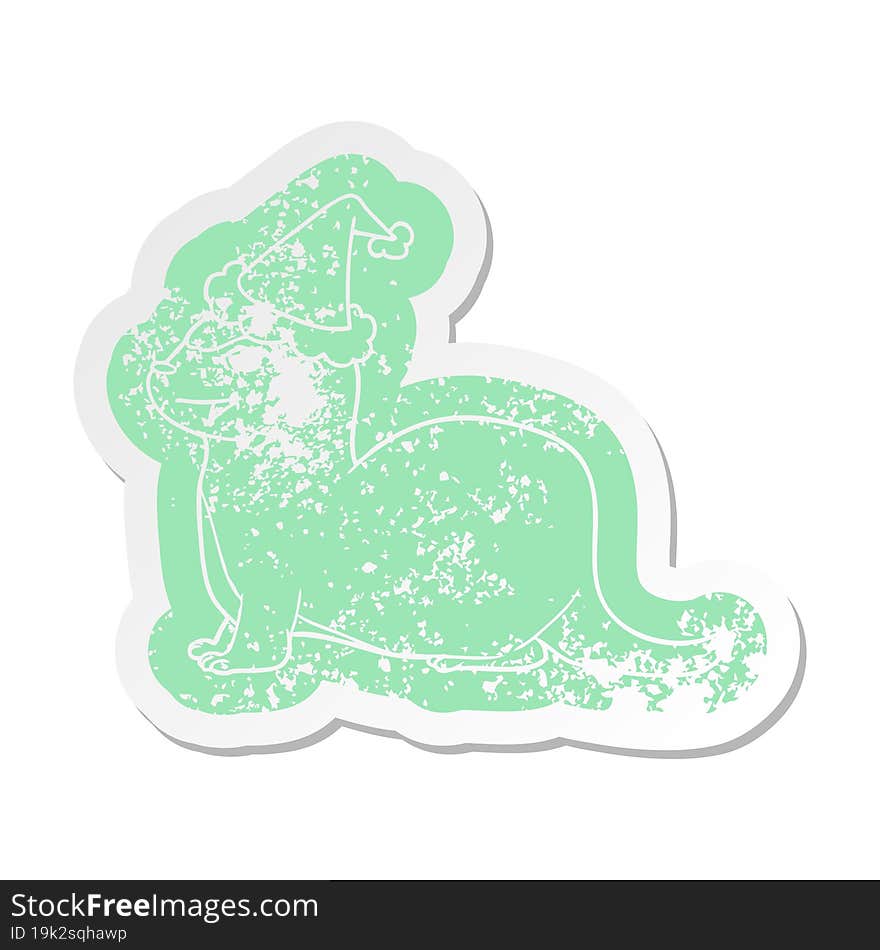 laughing otter cartoon distressed sticker of a wearing santa hat