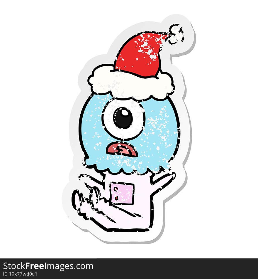 hand drawn distressed sticker cartoon of a cyclops alien spaceman wearing santa hat