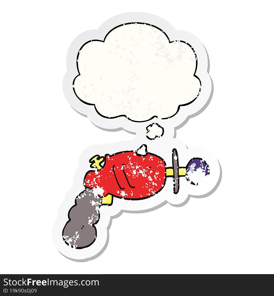 cartoon ray gun and thought bubble as a distressed worn sticker