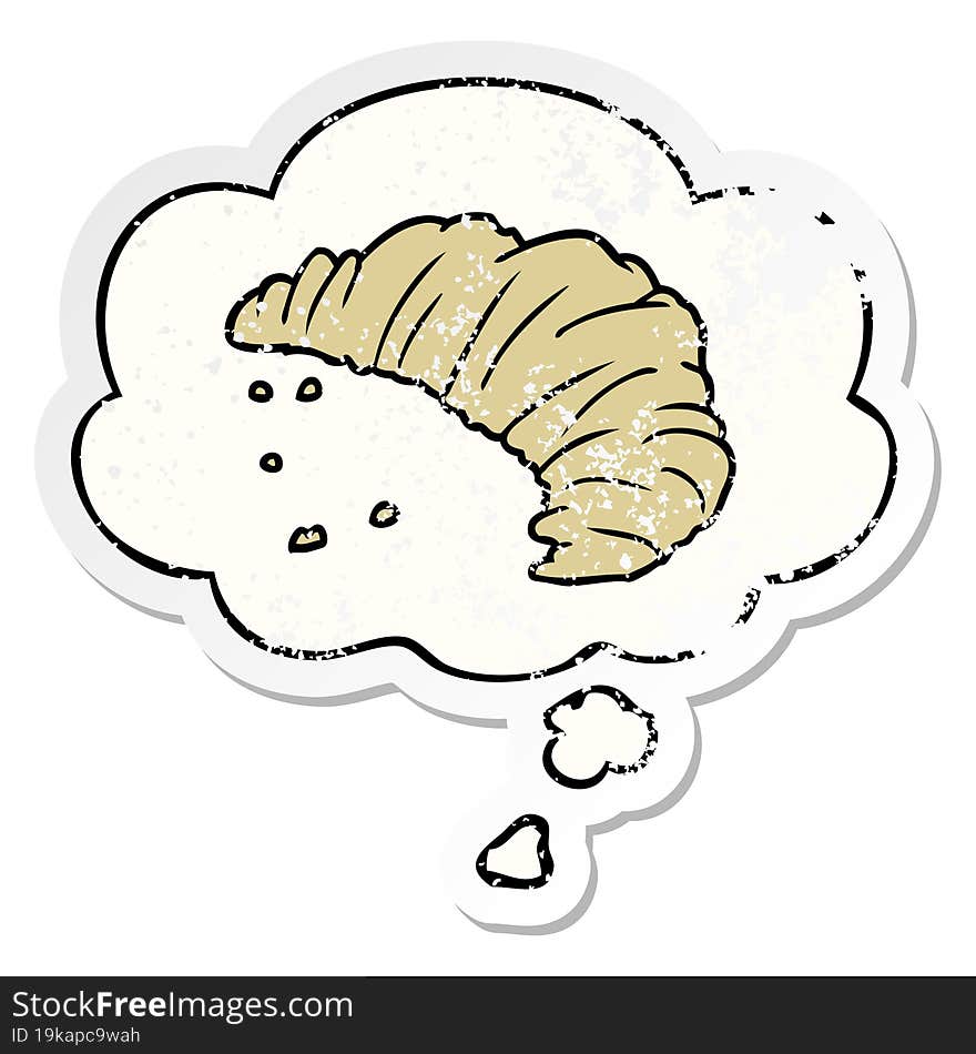 cartoon croissant and thought bubble as a distressed worn sticker