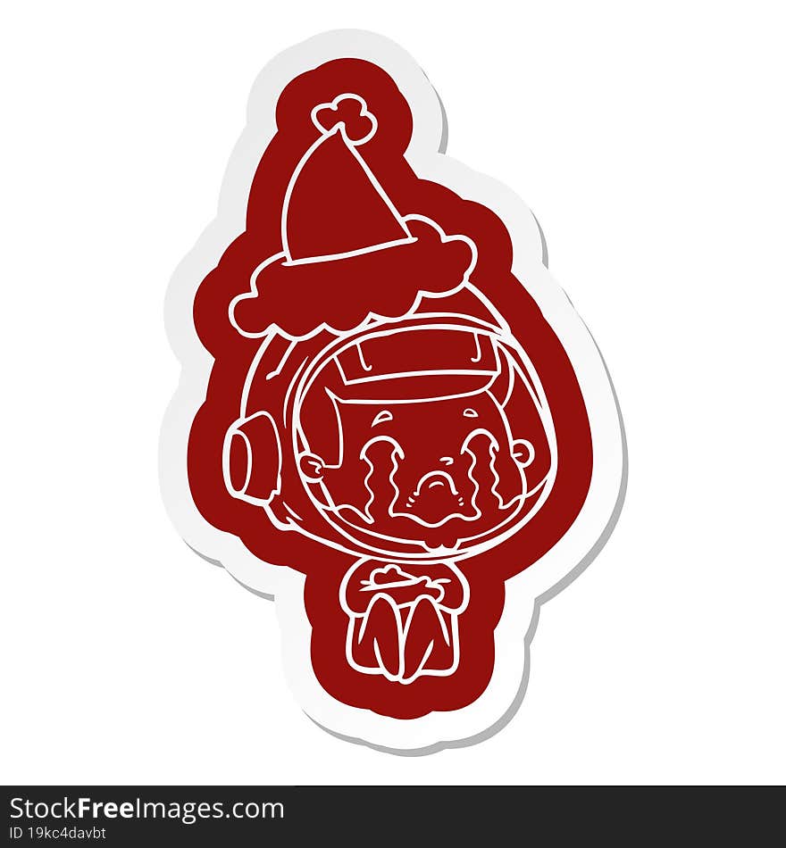 cartoon  sticker of a crying astronaut wearing santa hat