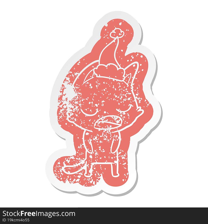 talking cat cartoon distressed sticker of a wearing santa hat