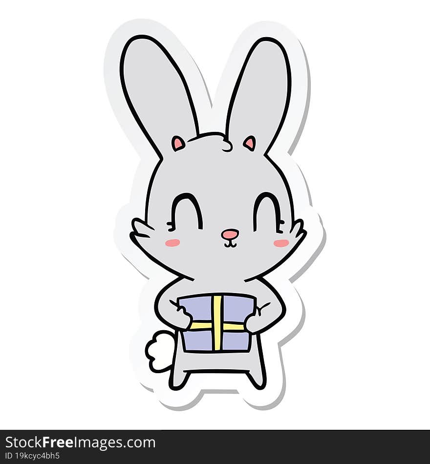 sticker of a cute cartoon rabbit with present