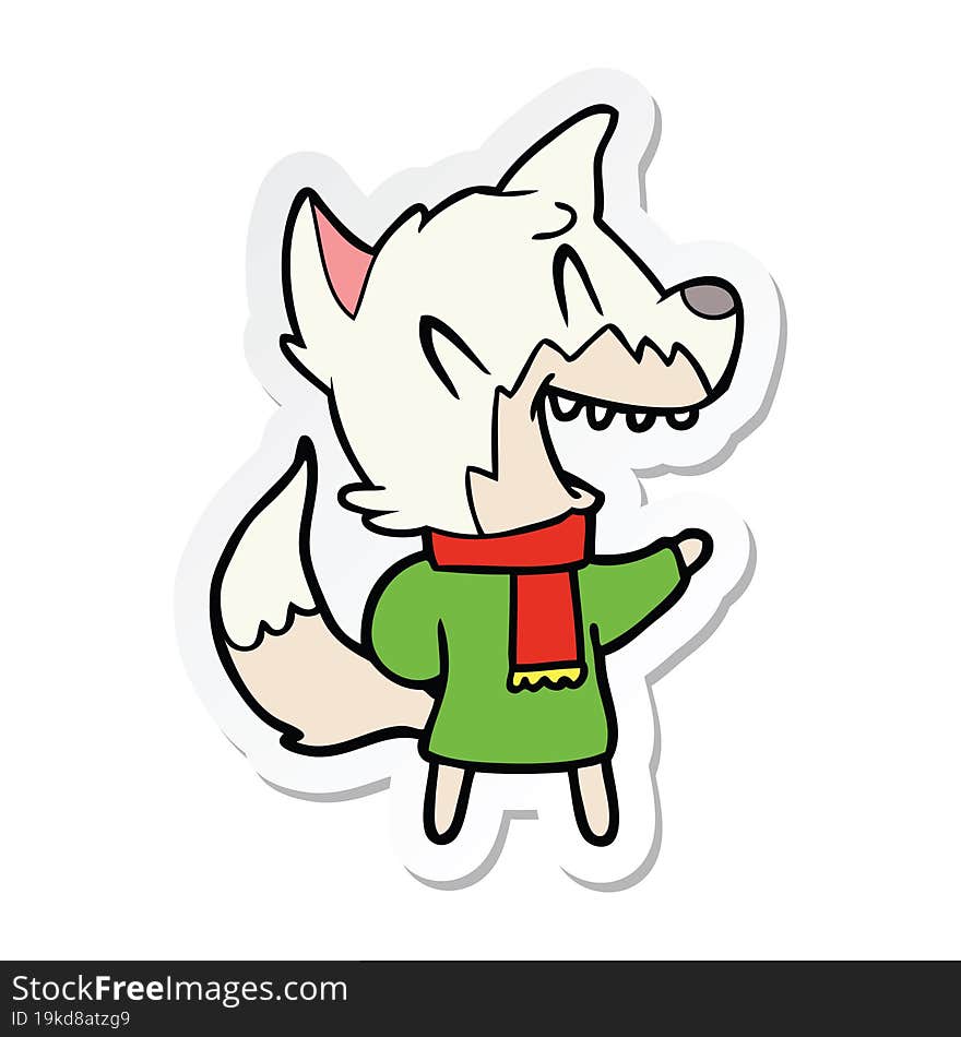 sticker of a laughing fox wearing winter clothes