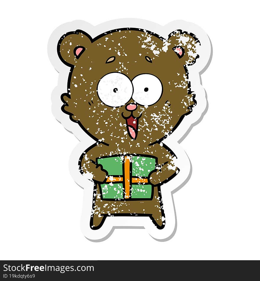 distressed sticker of a laughing teddy  bear with christmas present