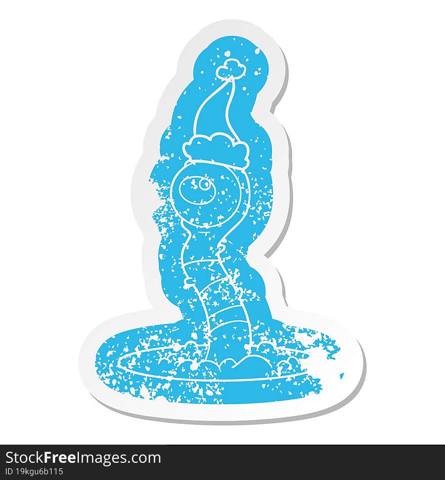 cartoon distressed sticker of a alien swamp monster wearing santa hat